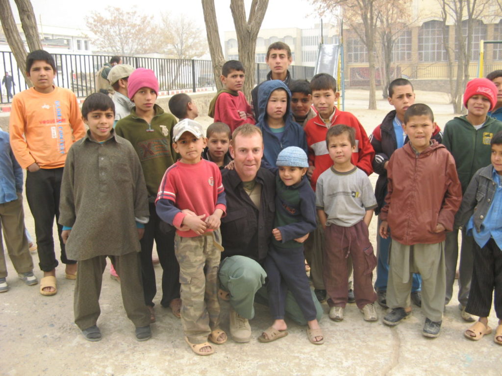 Philip McTigue in NY park with school children